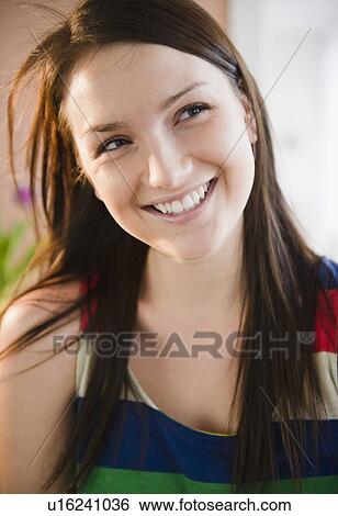 Stock Photograph - Portrait of smiling young woman. Fotosearch