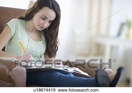 Portrait of teenage girl (14-15) doing homework View Large Photo Image Stock Photo - Portrait of teenage girl (14-15) doing homework. Fotosearch