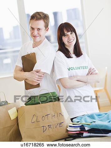 Portrait of volunteers organizing clothing drive View Large Photo Image Stock Photography - Portrait of volunteers organizing clothing drive. Fotosearch
