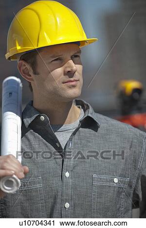 Portrait of worker holding blueprint View Large Photo Image Stock Image - Portrait of worker holding blueprint. Fotosearch