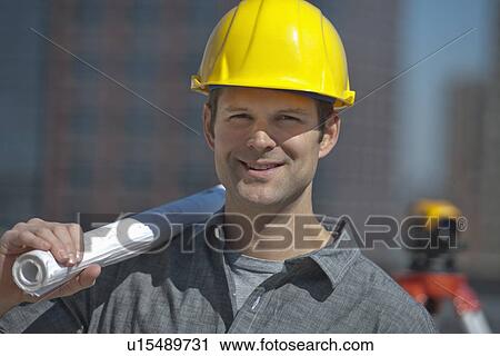 Portrait of worker holding blueprint View Large Photo Image Stock Image - Portrait of worker holding blueprint. Fotosearch