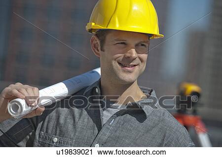 Portrait of worker holding blueprint View Large Photo Image Stock Image - Portrait of worker holding blueprint. Fotosearch