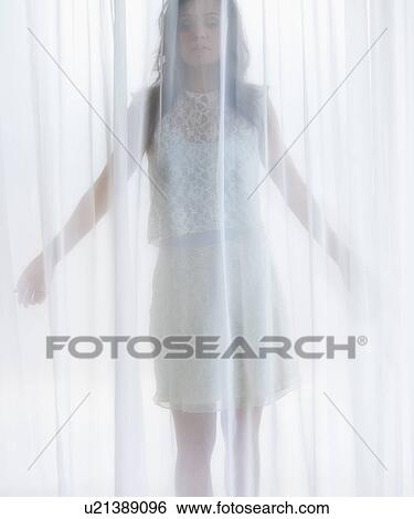 Portrait of young woman behind curtain View Large Photo Image Stock Photograph - Portrait of young woman behind curtain. Fotosearch