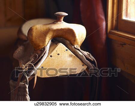 Saddle ion wooden stand View Large Photo Image Stock Photography - Saddle ion wooden stand. Fotosearch