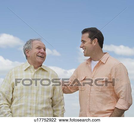 Stock Image - Senior father with adult son. Fotosearch
