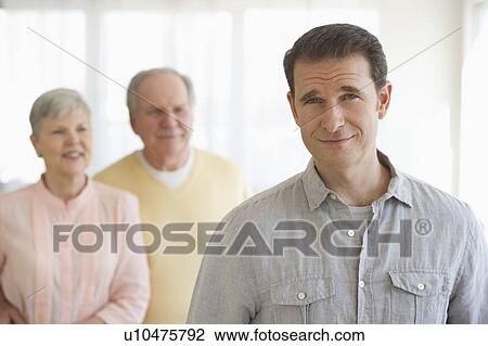 Stock Image - Senior parents with adult son. Fotosearch