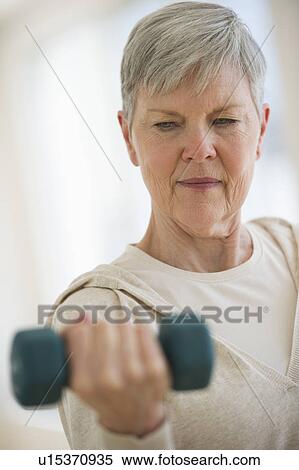 Senior woman lifting weights View Large Photo Image Stock Photography - Senior woman lifting weights. Fotosearch