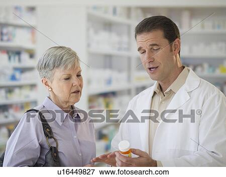 Stock Photo - Senior woman talking to pharmacist. Fotosearch