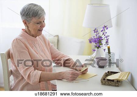 Stock Image - Senior woman writing letter. Fotosearch
