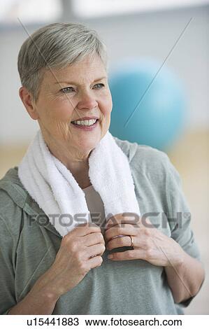 Stock Image - Smiling senior woman in gym. Fotosearch