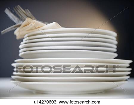Stack of plates and forks, studio shot View Large Photo Image Stock Image - Stack of plates and forks, studio shot. Fotosearch