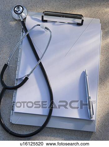 Stock Image - Stethoscope, clipboard and pen, studio shot. Fotosearch