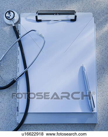 Stock Photo - Stethoscope, clipboard and pen, studio shot. Fotosearch