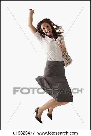Stock Photo - Studio shot of cheering woman. Fotosearch