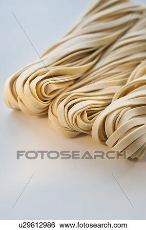 Stock Photograph - Studio shot of fresh linguini pasta. Fotosearch