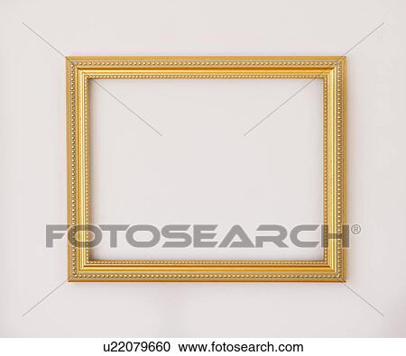 Stock Image - Studio shot of golden picture frame on white background. Fotosearch
