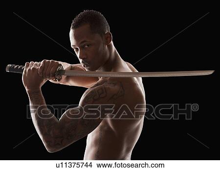 Picture - Studio shot of martial arts practitioner with Katana sword. Fotosearch