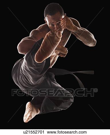 Studio shot of martial arts practitioner in mid-air kick View Large Photo Image Stock Image - Studio shot of martial arts practitioner in mid-air kick. Fotosearch