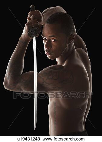 Stock Photo - Studio shot of martial arts practitioner with Katana sword. Fotosearch