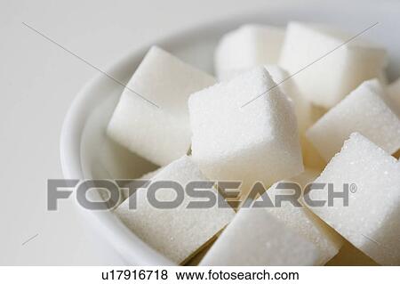 Stock Photo - Studio shot of sugar cubes in bowl. Fotosearch