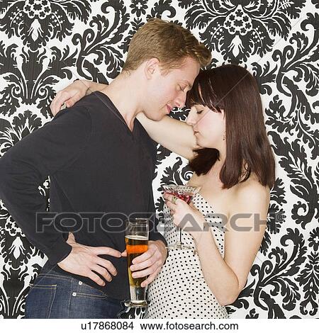 Picture - Studio shot of young couple face to face. Fotosearch