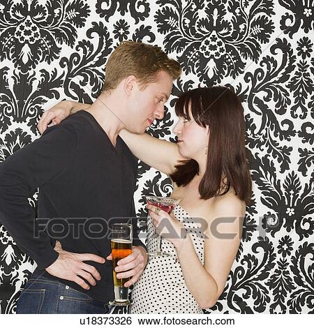 Stock Photograph - Studio shot of young couple face to face. Fotosearch
