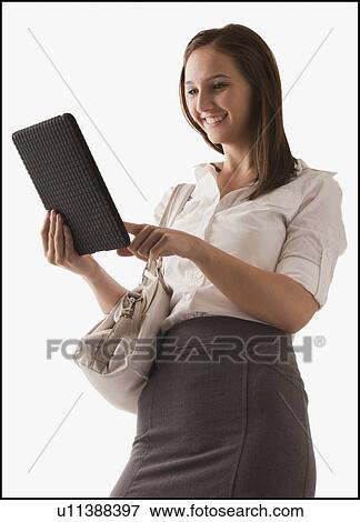Studio shot of young woman with digital tablet View Large Photo Image Stock Photo - Studio shot of young woman with digital tablet. Fotosearch