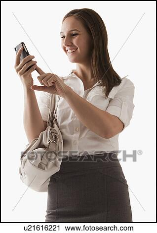 Studio shot of young woman with mobile phone View Large Photo Image Stock Image - Studio shot of young woman with mobile phone. Fotosearch