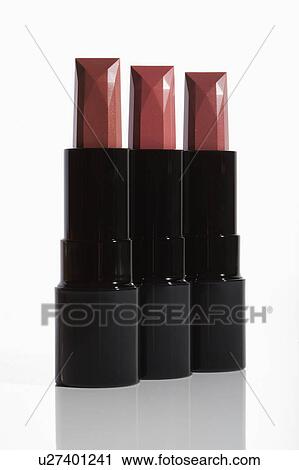 Stock Image - Studio Shot, Three pink lipsticks in row. Fotosearch