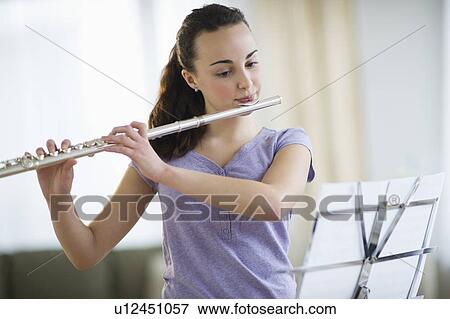 Teenage girl (14-15) playing flute View Large Photo Image Stock Photo - Teenage girl (14-15) playing flute . Fotosearch