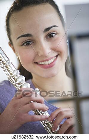 Teenage girl (14-15) posing with flute View Large Photo Image Stock Image - Teenage girl (14-15) posing with flute . Fotosearch