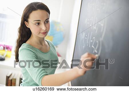 Teenage girl (14-15) writing on blackboard View Large Photo Image Stock Photo - Teenage girl (14-15) writing on blackboard. Fotosearch