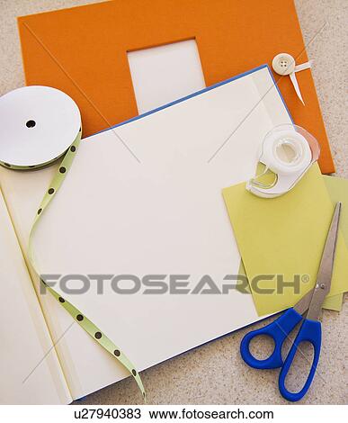 Stock Image - Unfinished scrapbook and materials. Fotosearch