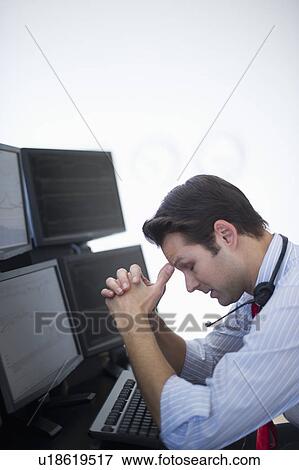 Stock Photo - Upset financial worker analyzing data displayed on computer screen. Fotosearch