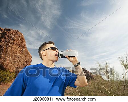 USA, Arizona, Phoenix, Man drinking from bottle View Large Photo Image Stock Image - USA, Arizona, Phoenix, Man drinking from bottle . Fotosearch