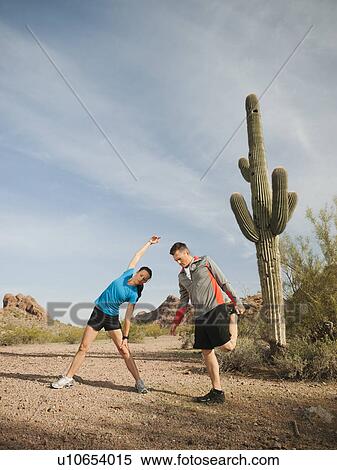 USA, Arizona, Phoenix, Mid adult man and young woman exercising on desert View Large Photo Image Stock Photography - USA, Arizona, Phoenix, Mid adult man and young woman exercising on desert. Fotosearch