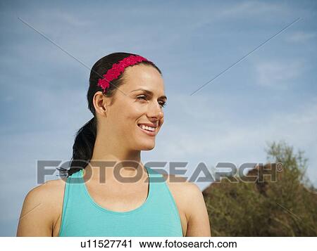 Stock Image - USA, Arizona, Phoenix, Portrait of young woman. Fotosearch