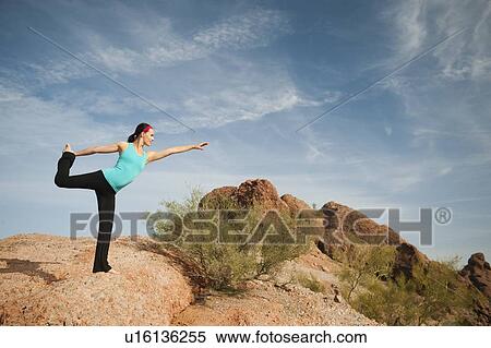 Stock Photography - USA, Arizona, Phoenix, Young woman exercising on desert. Fotosearch