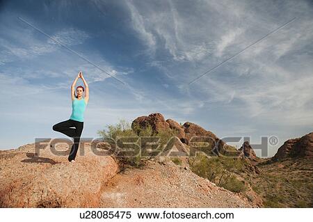 Stock Photography - USA, Arizona, Phoenix, Young woman exercising on desert. Fotosearch