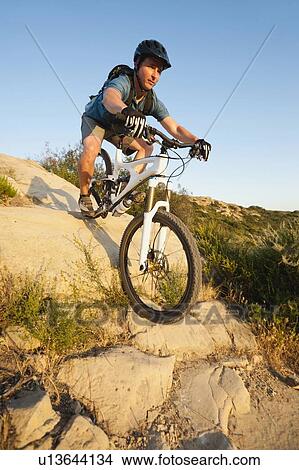 Picture - USA, California, Laguna Beach, Man cycling down hill. Fotosearch