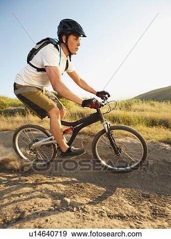Stock Photo - USA, California, Laguna Beach, Man cycling down hill. Fotosearch