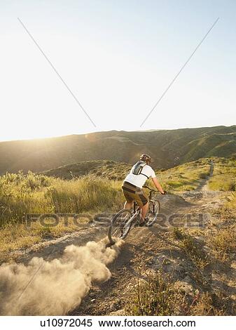 USA, California, Laguna Beach, Man cycling down hill View Large Photo Image Stock Photography - USA, California, Laguna Beach, Man cycling down hill. Fotosearch