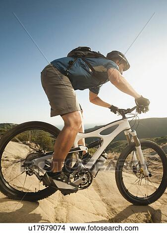 Picture - USA, California, Laguna Beach, Mountain biker riding downhill. Fotosearch
