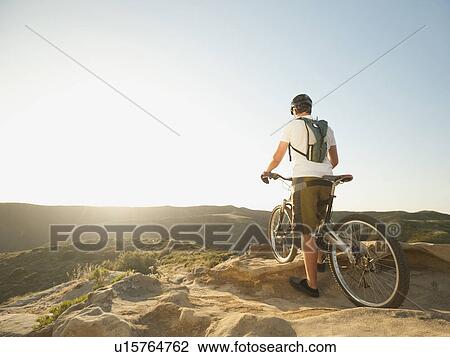 USA, California, Laguna Beach, Mountain biker on top of hill View Large Photo Image Stock Image - USA, California, Laguna Beach, Mountain biker on top of hill. Fotosearch