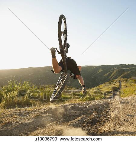 Stock Photo - USA, California, Laguna Beach, Mountain biker falling of his bike. Fotosearch
