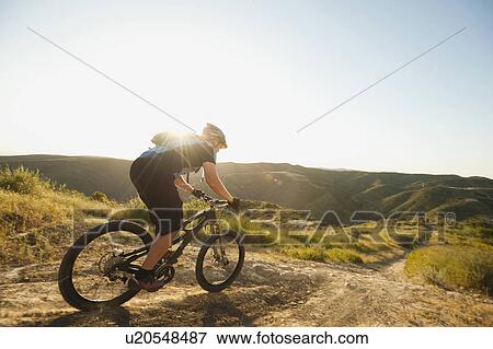 USA, California, Laguna Beach, Mountain biker riding downhill View Large Photo Image Stock Photo - USA, California, Laguna Beach, Mountain biker riding downhill. Fotosearch