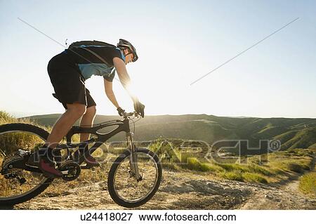 Stock Photo - USA, California, Laguna Beach, Mountain biker riding downhill. Fotosearch