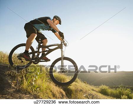 USA, California, Laguna Beach, Mountain biker riding downhill View Large Photo Image Stock Photograph - USA, California, Laguna Beach, Mountain biker riding downhill. Fotosearch