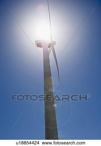 Picture - USA, California, Palm Springs, Coachella Valley, San Gorgonio Pass, Wind turbine against blue sky in sunlight. Fotosearch