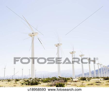 Stock Image - USA, California, Palm Springs, Coachella Valley, San Gorgonio Pass, Wind turbines with mountains in background. Fotosearch
